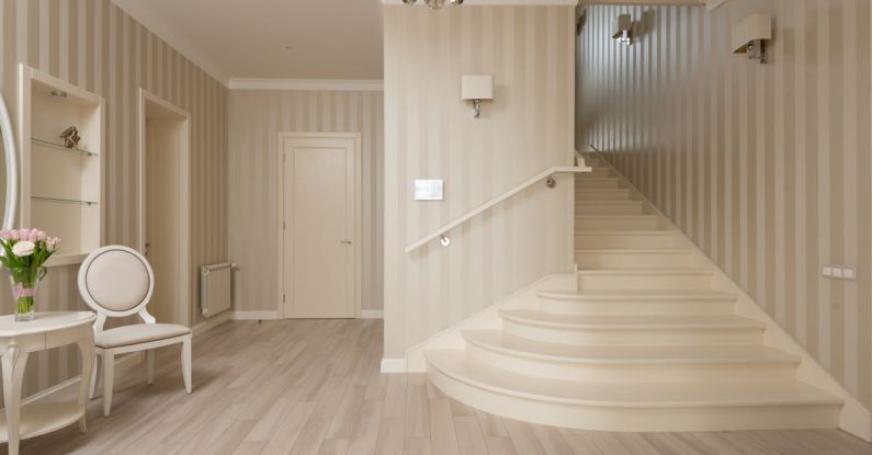 Built-in Shelves - Interior of spacious cozy hallway with beige striped walls and light stairs and furniture