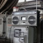 Garage Storage - Old fashioned cassette player placed in shabby garage near old industrial equipment